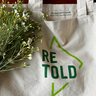 The Retold tote with wallflowers. Label inside tote reads: "This bag is earth friendly. Made with recycled cotton"